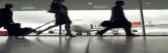 People walking through airport, silhouette (focus on aeroplane)